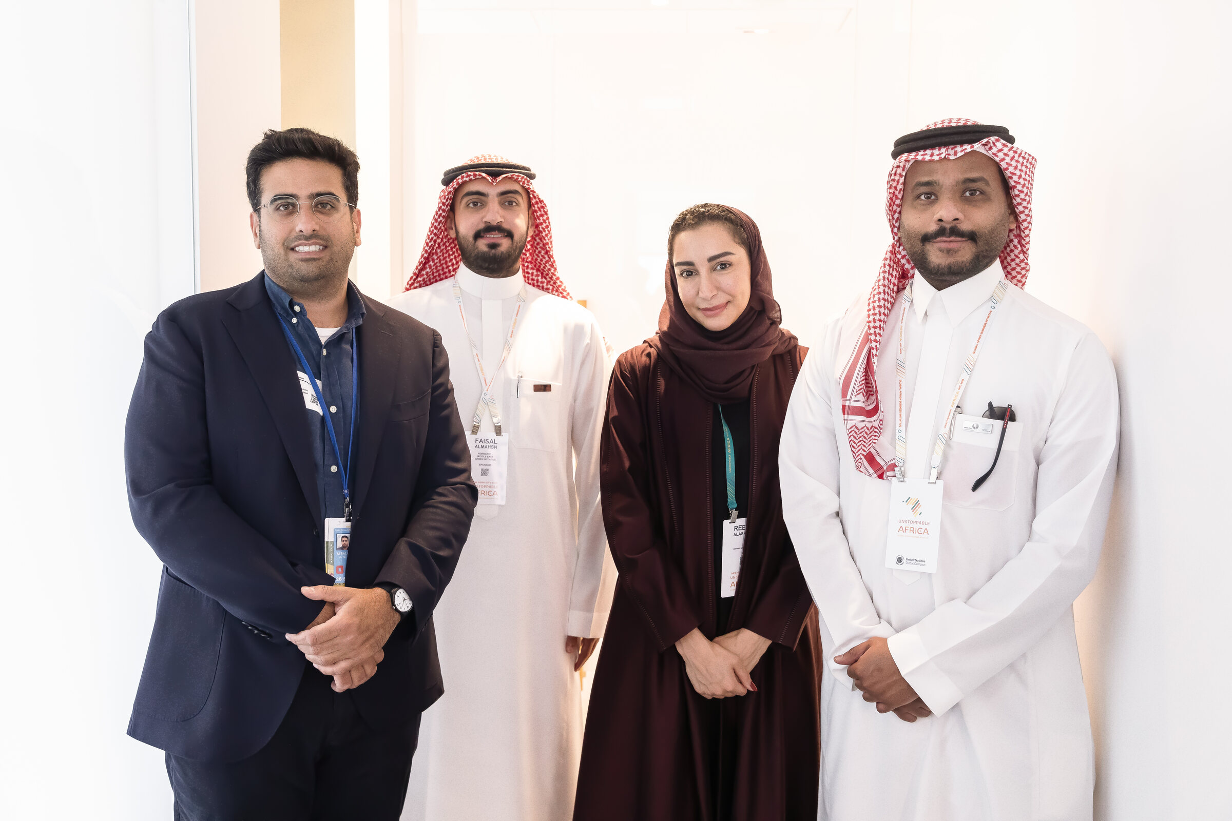 Four conference attendees standing together at an international summit