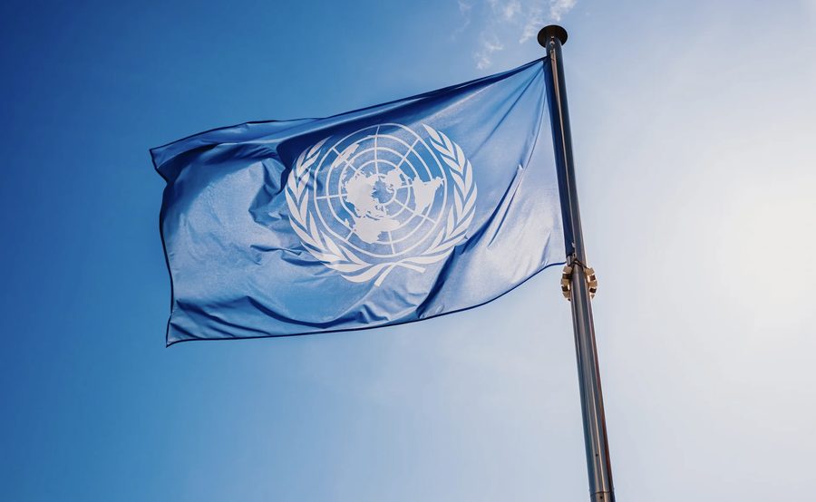 Flag of the United Nations against a blue sky